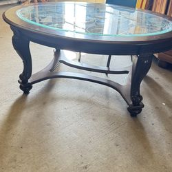 Elegant Oval Coffee Table – Wood & Glass with Metal Scroll Design