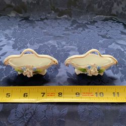 Two porcelain Gold Trimmed figurines with raised flowers