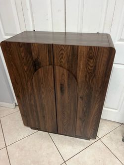Brand new walnut-finish wooden accent storage cabinet features distinctive curved door