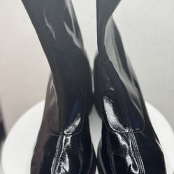 This is a pair of black patent leather platform boots.