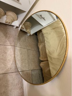 round mirror with a gold frame