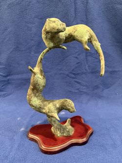 Playful Otters Sculpture