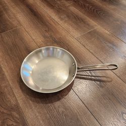 Simply Calphalon Stainless Steel 10" skillet (model 1390), which features a durable stainless steel construction, designed to be versatile and compati