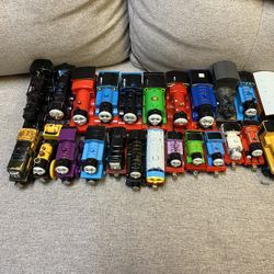 Lot of Thomas the Choo Choo Train toys and trans. Multiple trains, cars, etc