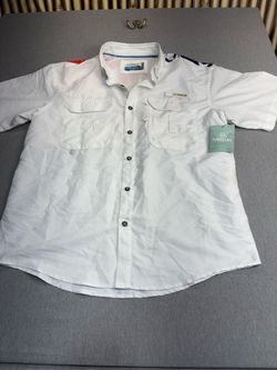 Magellan Outdoors Men's Lake Fork Americana Fishing Shirt features a white design with an American flag print on the shoulder.