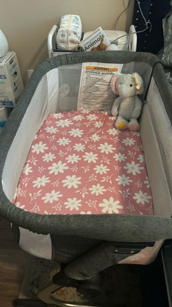 Baby bedside sleeper , excellent condition, with 3 baby girl sheets .
