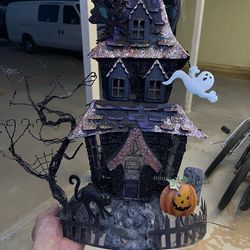 haunted mansion tea light holder, likely the Cody Foster or a similar metal glittered haunted house decoration.