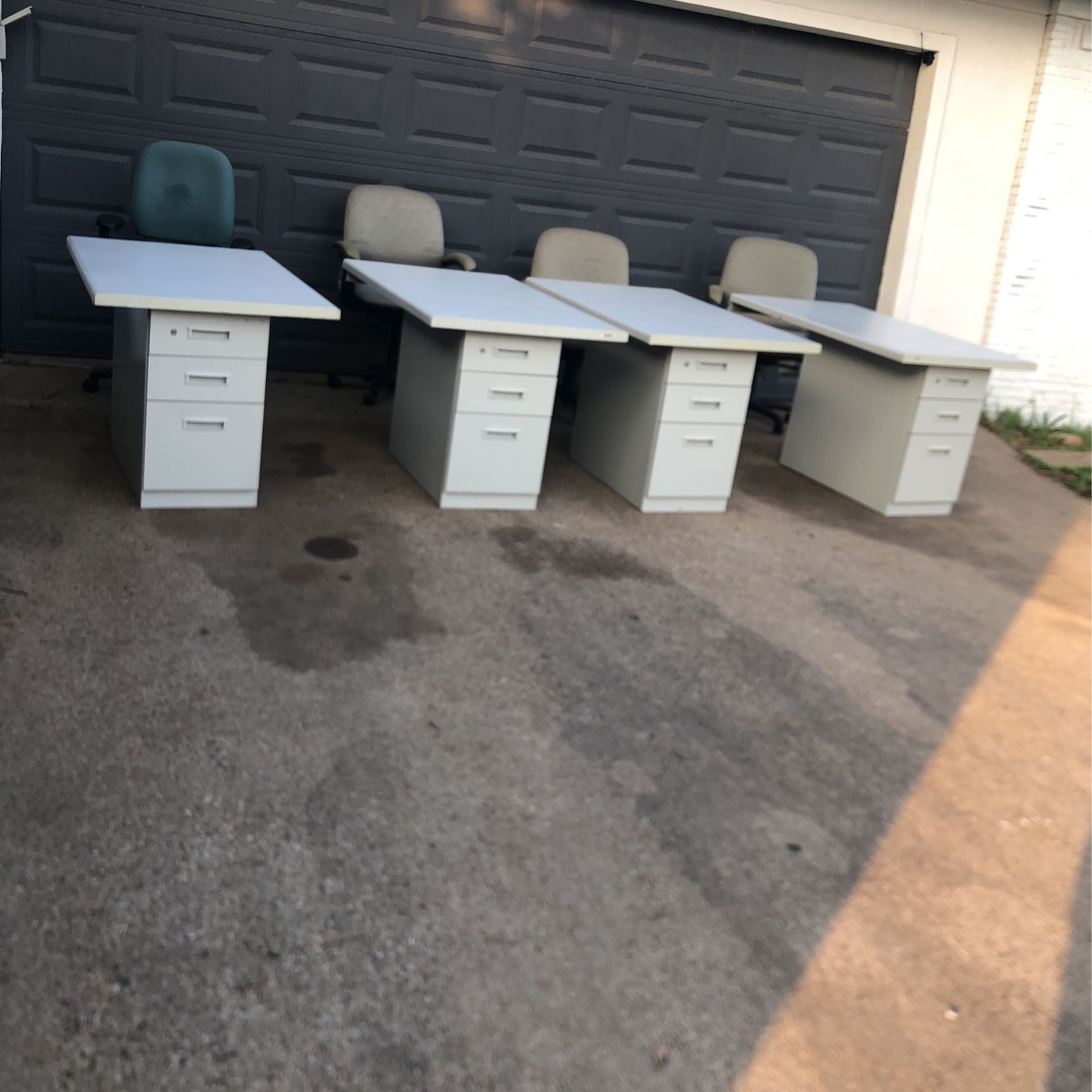 I am selling these 4 filing cabinets with their respective desk pieces and secretarial chairs.
