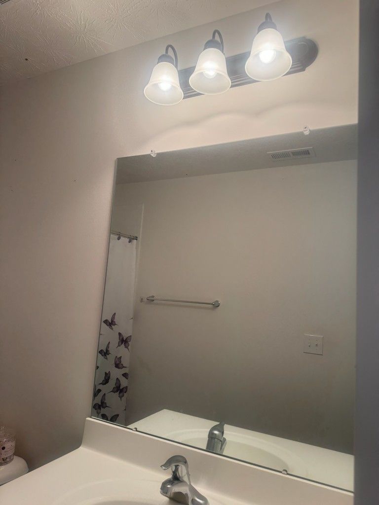 Bathroom Cabinets, Toilet, Lights, And Mirror