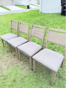 Selling 4 wooden dining chairs.