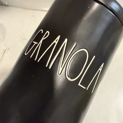 Stylish black Rae Dunn canister. Has 'GRANOLA' written on it. Comes with its lid. Great for kitchen storage.