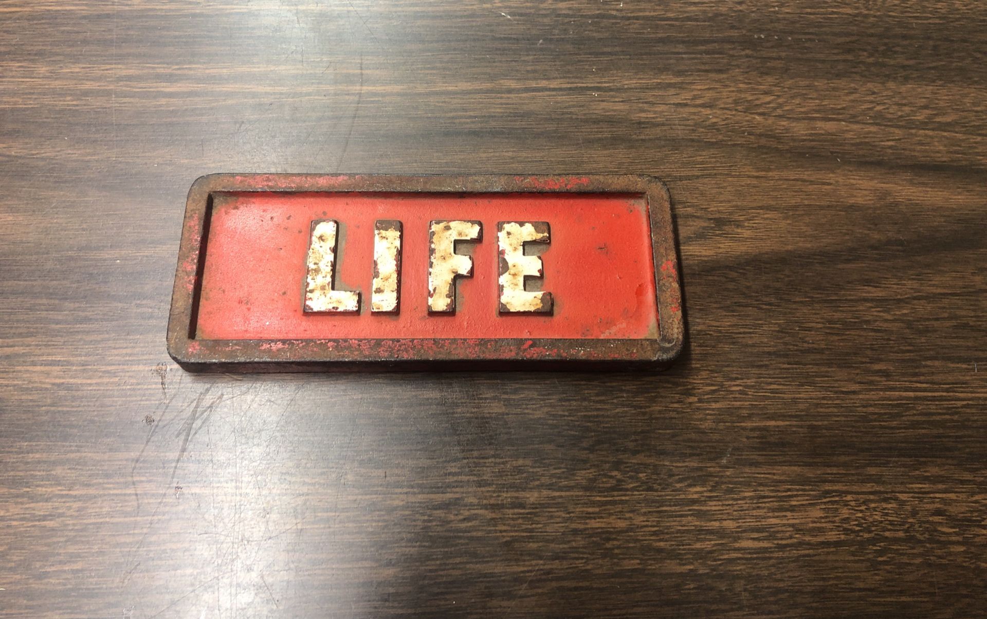 Vintage Cast Iron Life Brick Newspaper Weight