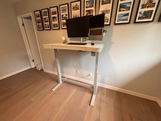 Stand-up desk with 2 usb chargers and charging pad.