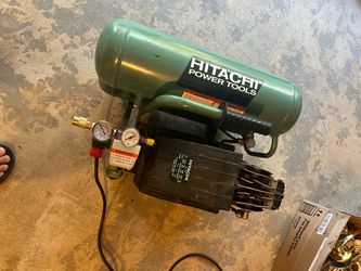 Hitachi EC12 twin-stack air compressor, featuring a 4-gallon tank capacity and a 2 HP motor.