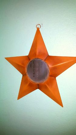 yelliw tin star mirror...18 inches tall..Good condition!