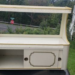 Vintage  metal rack with sliding door  has gold trim