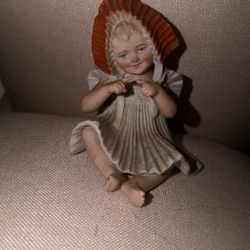 antique German bisque porcelain "piano baby" figurine, possibly from the manufacturer Gebruder Heubach.  