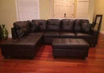 Brown leather sectional couch and ottoman
