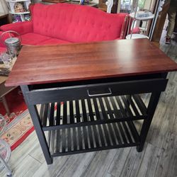 Casual Home kitchen island with a solid wood surface and black finish.