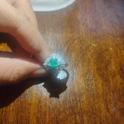Ring With  Diamonds With A Emerald In The Middle 