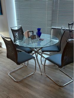 Glass dining room table with chairs