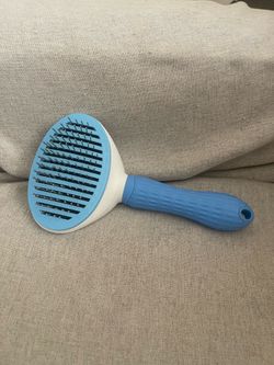 Self cleaning pet grooming brush