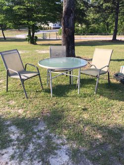 Outdoor round glass table with chairs