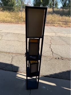 Lamp with shelves and two side lamps.