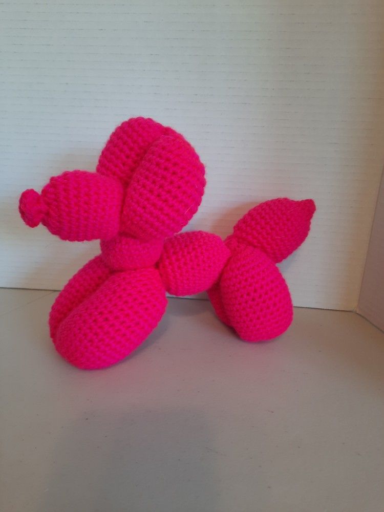 Hot pink crocheted balloon dog plushie 