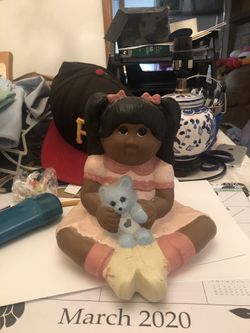 Girl holding teddy bear statue 1985