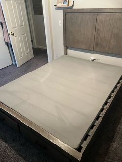 Queen size wooden bed frame with drawers.