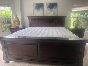 Ashley King Size Dark Wood Panel Bed Frame with mattress and two nightstands