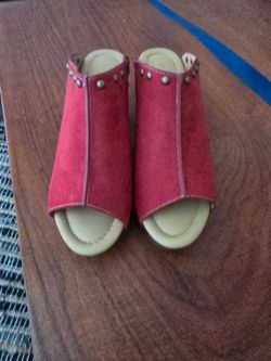 Comfort Est.1946 slip-on sandals in red suede. Soft padded footbed for all-day wear. Easy pull-on design with decorative stud accents. Durable sole fo