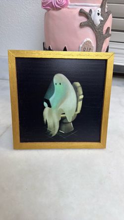 Ghost sitting on toilet frame