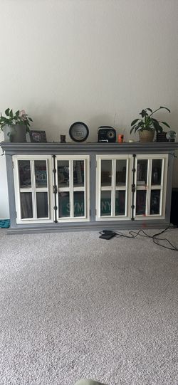 Distressed grey and white window pane cabinet