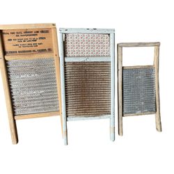 Collection of antique wooden and metal washboards, including one from Columbus Washboard Co.