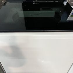 The LG WT8405CW is a 5.3 cu. ft. mega-capacity top-load washer with an agitator, measuring approximately 27" W x 43" H x 28.38"