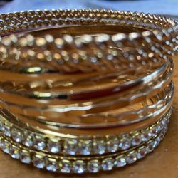 A Dozen Gold Plated Bangle Bracelets 
