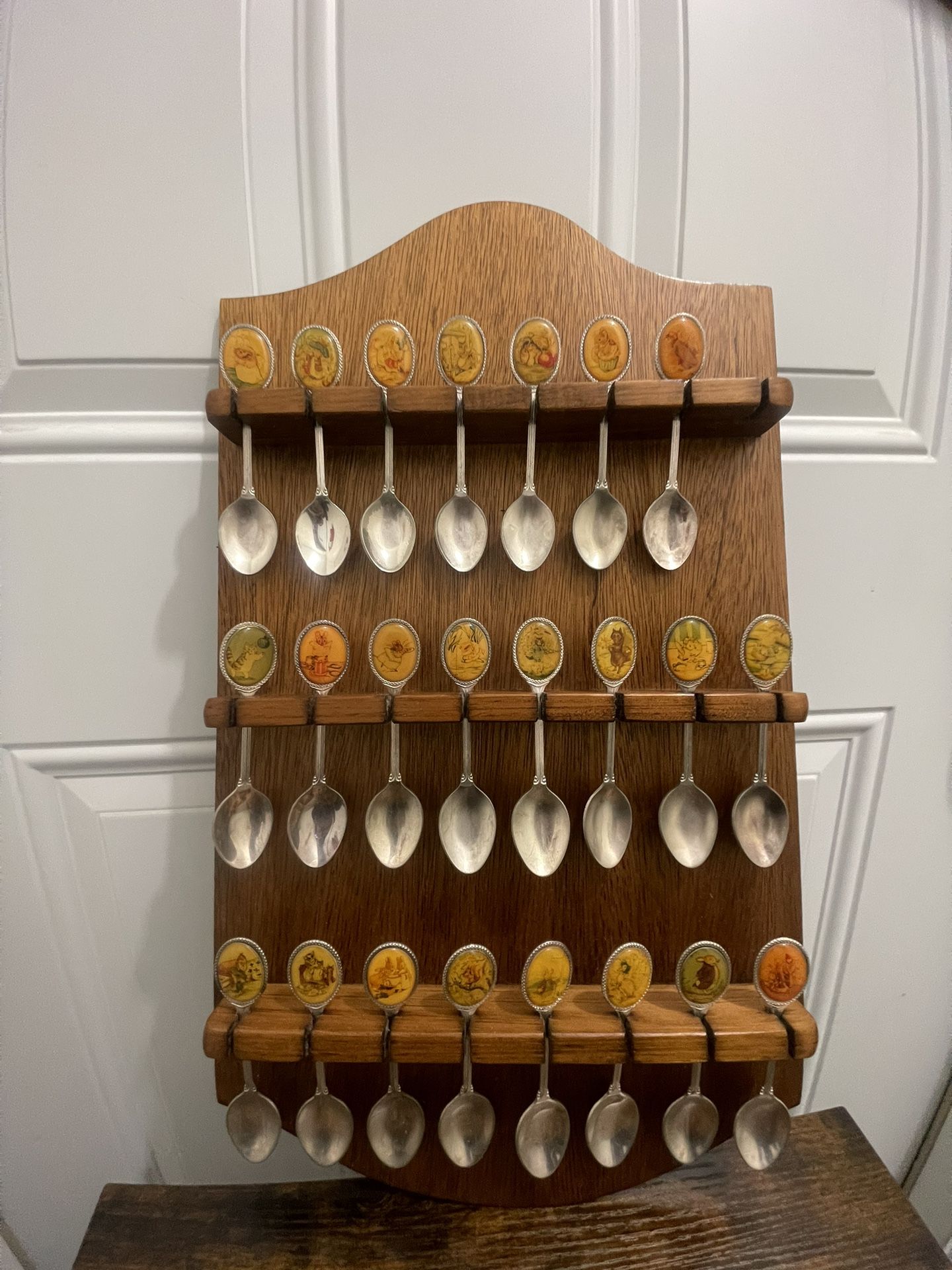 Vintage Beatrix Potter Metal Spoon Collection on Wooden Rack