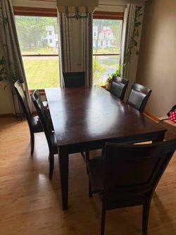 Dark wood dining table with 6 chairs