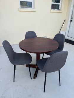 Round table with 4 chairs; the table base might need a little touching up with paint. Dimensions: 34