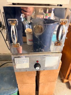 Stainless steel Shimpo ConeArt kiln with a front-loading door. This unit has dual tension springs on the sides and a front-mounted control knob. The e