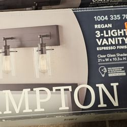 Hampton Bay

Regan 21 in. 3-Light Espresso
Bronze Bathroom Vanity Light
with Clear Glass Shades