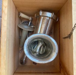 Vintage meat grinder kit featured in a wooden storage box