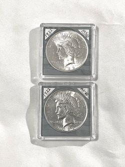 Uncirculated sealed in cases (2)  1922 piece silver dollars. Valued at $103 each.