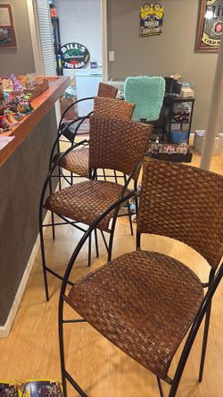 Four (4) black metal and wicker barstools