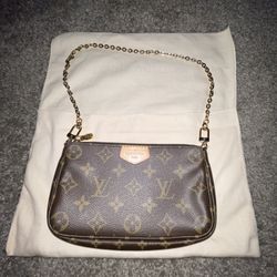 Louis Vuitton Mini Pochette Accessoires in the classic Monogram canvas pattern. 