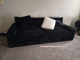 Black couch with two pillows