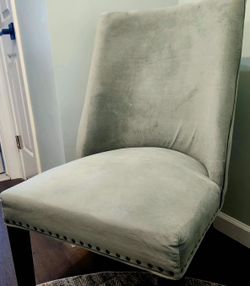 2 sage green chairs, featuring luxurious fabric, elegant bronze nailhead trim, cherry Legs