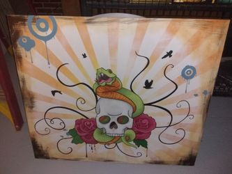 Skull and snake painting on wood.